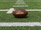 a football resting on football field turf