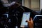 Man researching stocks on an iPhone while driving his BMW