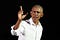 Former President Obama speaking against a black background.
