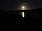 Picture of the moon rising above Schulz canal. taken at night on a phone with a shaky hand.