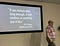 On screen slide says:“if you torture data long enough, it will confess to anything you like” — R.H. Coase, British economist”