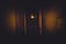 Old corridor with an open door and locked ones. Dark, gloomy, and fear-inducing.
