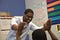 A teacher in a white shirt giving a student a double high five