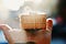 Small packaged box with fragile written on it resting on someone’s open palm