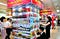 Korean shoppers scan codes next to printed products on pillars.