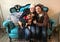 Megan and Tim pose happily with their new dog, Arthur, a Cairn terrier-chihuahua mix, on a blue couch.