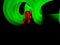 A photo of a person covering their face with their hands. They are illuminated red, and there are green circles around her.