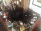 My black cat Huginn sitting on my long, colorful paper chain of debt.