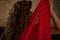sensual woman holding up a red lace veil