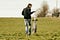 Man with his dog out in a field of grass.