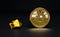 A lump of gold beside a gold Bitcoin