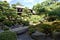 View over Japanese garden with trees and the hotel in the background