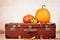 Pumpkins and vintage suitcase for thanksgiving travel