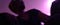 A blurry image in purple tones, of a female presenting person, semi reclined, looking over their shoulder.