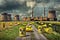 Yellow barrels with the biohazard symbol on them in front of a nuclear power plant.
