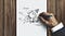 Man drawing a rocket ship labeled ‘Start up’