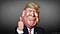 A manipulated photograph caricature of President Donald Trump giving a thumbs up sign against a gray gradient background.