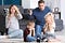 Parents arguing with sad, frustrated children on living room couch