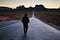 Man walking down the center of the road, Monument Valley
