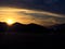 The sun setting behind the mountains