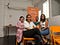 Anisah, Guy, Serena and Rachel sitting on orange chairs