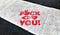 The words “Fuck you” spray painted in red on a pedestrian zebra crossing
