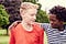 Portrait of a black boy standing with a white boy.