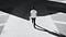 Person walking on concrete road, towards a shadow, image black and white