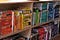 A bookcase of UX design books organised by colour