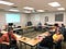 A quick group shot of the CSTA Spokane group, showing 12 people facing the camera around a rectangular table arrangement.