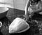 Black and White image of child kneading bread dough