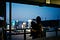 Mother with child looking out window at twilight.