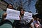 Journalists hold signs during a protest against the ongoing internet restrictions outside of the Kashmir Press Club.