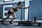 woman pushing prowler sled
