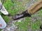 2 pairs of legs and a hose with water shooting on a raised boot