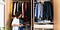 An individual organizing their closet.