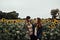 two women friends hugging in sunflower field
