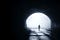 A dark tunnel, with a distant burst of sunshine framing a distant individual walking towards us.