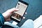 Hand holding a cell phone showing people’s pictures.