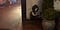 Street art of a girl, sitting in a corner, maybe with a book, looking a bit.