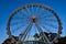 A tall ferris wheel as seen from the ground.