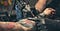 close up equipment for making tattoo art. Man doing picture on hand of woman