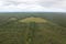 An aerial view of a mowed field surrounded by natural vegetation