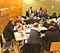 Room full of people — about 3 table groups of people chatting