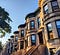 A block of brownstone apartments in Brooklyn as the sun sets