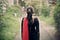 A woman walking into a forest. You Don’t Have to Be a Perfectionist to Write