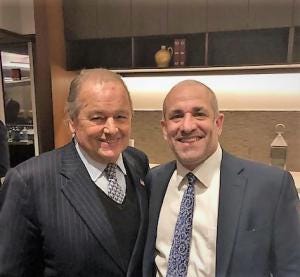 Steven Odzer smiling with associate