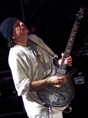 Santana playing a PRS guitar.