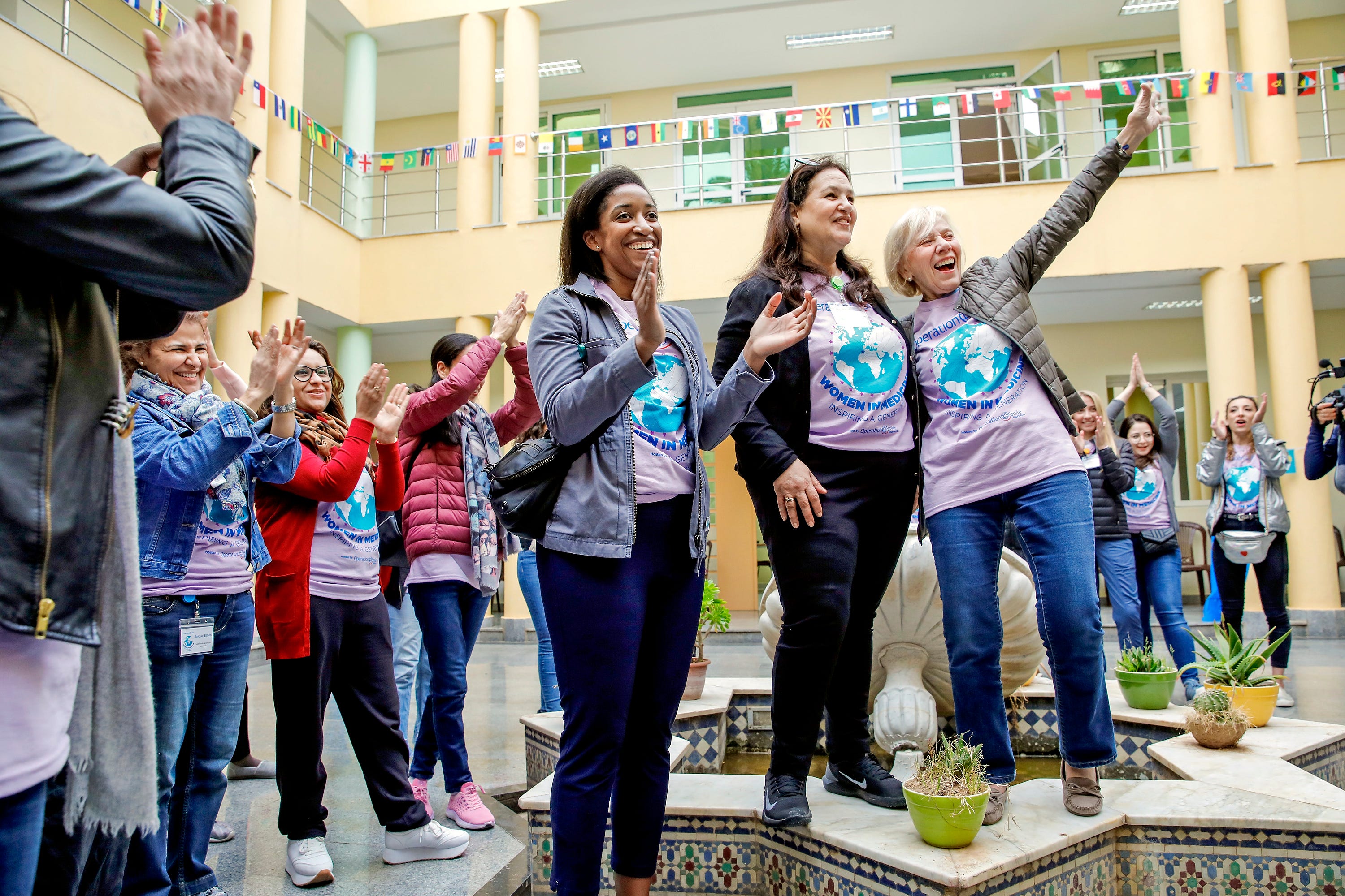 Naikhoba stands with two female leaders of Operation Smile.