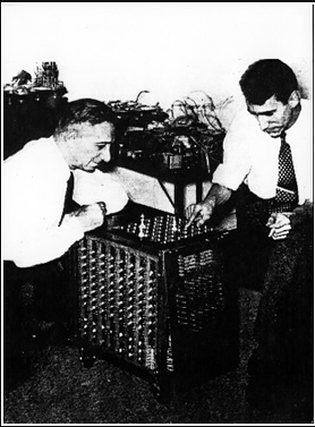 Claude Shannon demonstrates a chess-playing automaton he built for a limited version of chess, to chess champion Edward Laske